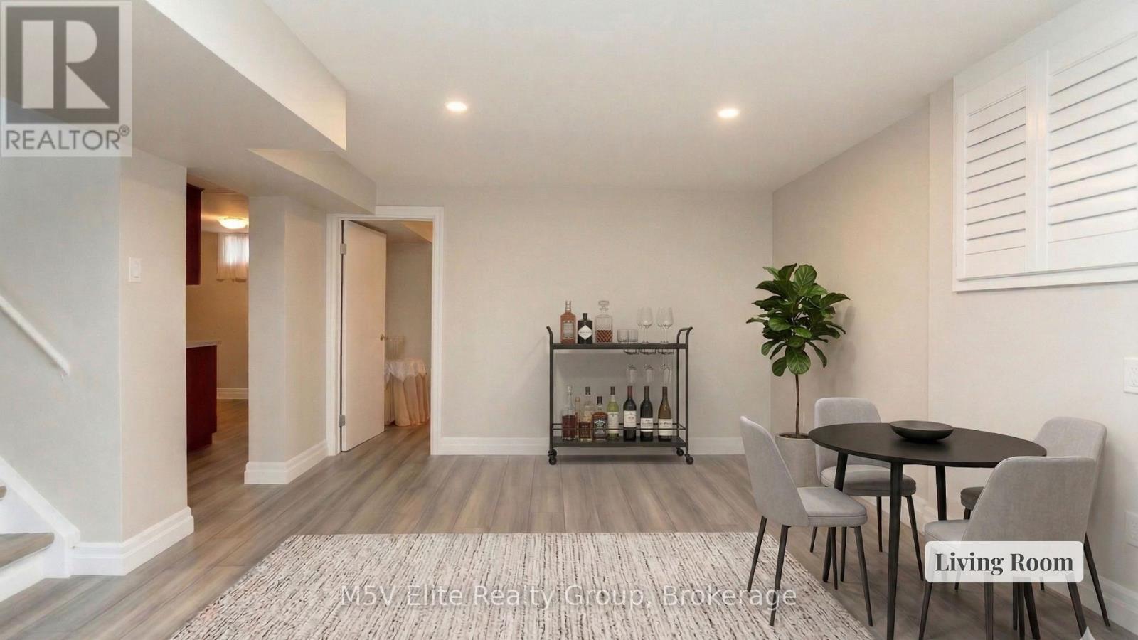 A living room with a table, chairs, and a wine rack.