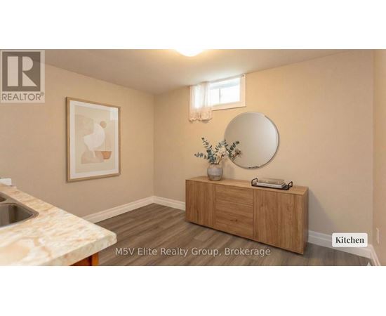 A kitchen with a sink, a mirror and a cabinet.
