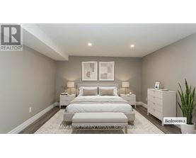 A bedroom with a large bed, two nightstands, and a plant.