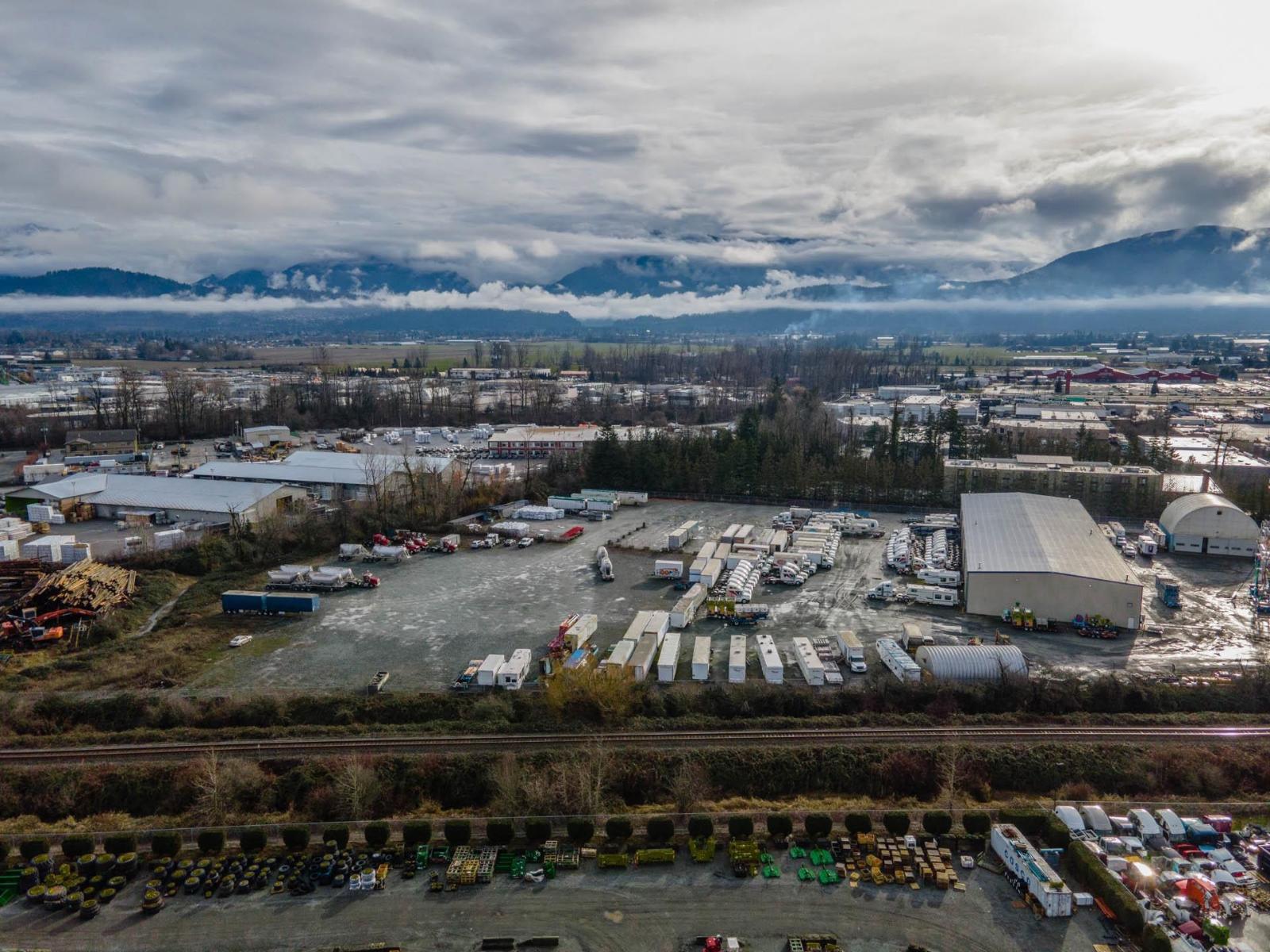 An aerial view of a parking lot with a mountain range in the background.