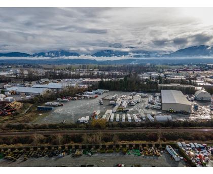 An aerial view of a parking lot with a mountain range in the background.