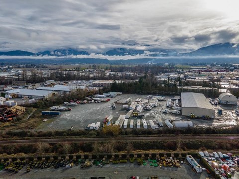 An aerial view of a parking lot with a mountain range in the background.