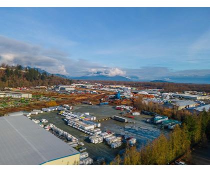 A large industrial area with a parking lot and buildings.