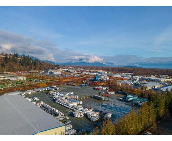 A large industrial area with a parking lot and buildings.