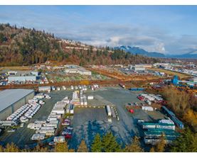 A large industrial area with numerous buildings and vehicles.