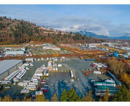 A large industrial area with numerous buildings and vehicles.