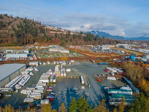 A large industrial area with numerous buildings and vehicles.