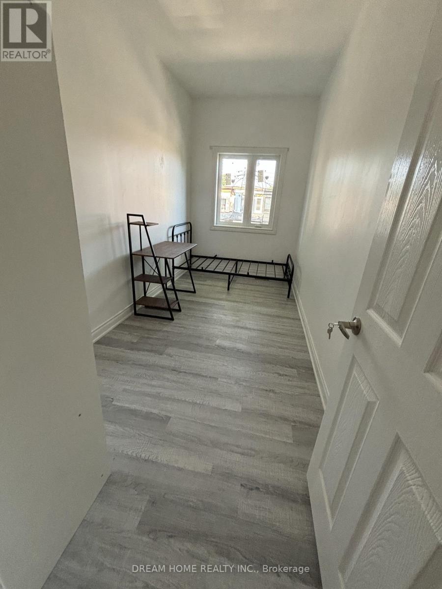 A hallway with a bench and a window.