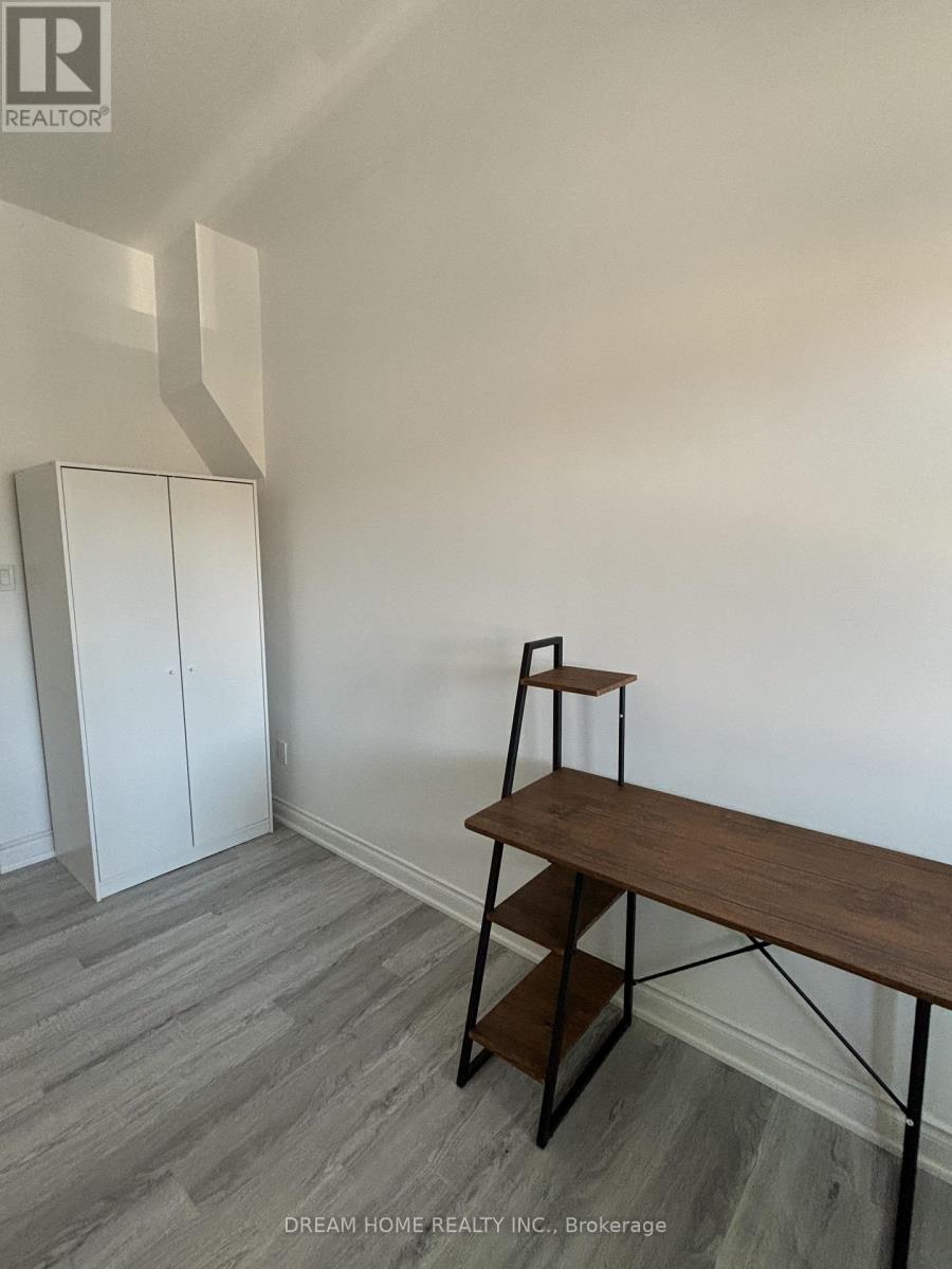 A room with a wooden table and a white cabinet.