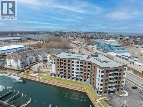 A large building with a boat docked in front of it.