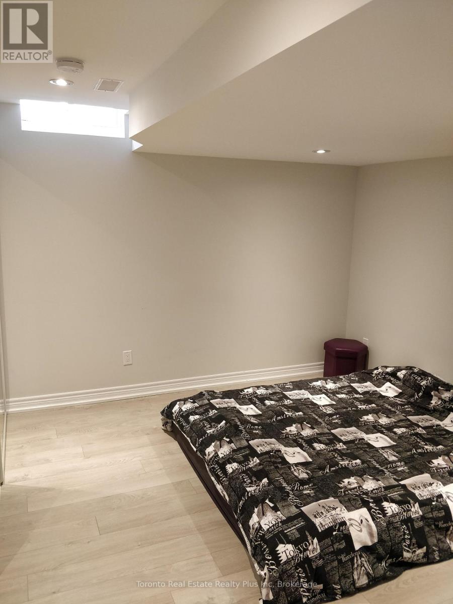 A bedroom with a bed and a red stool.