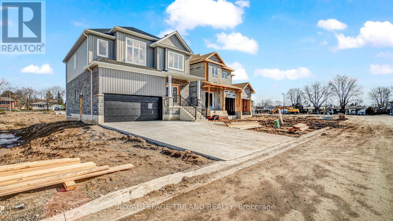 A house under construction with a clear sky in the background.