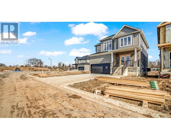 A construction site with a partially built house and a truck parked in front.