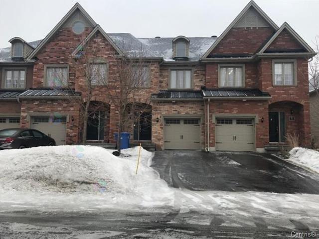 A large house with a driveway and garage.