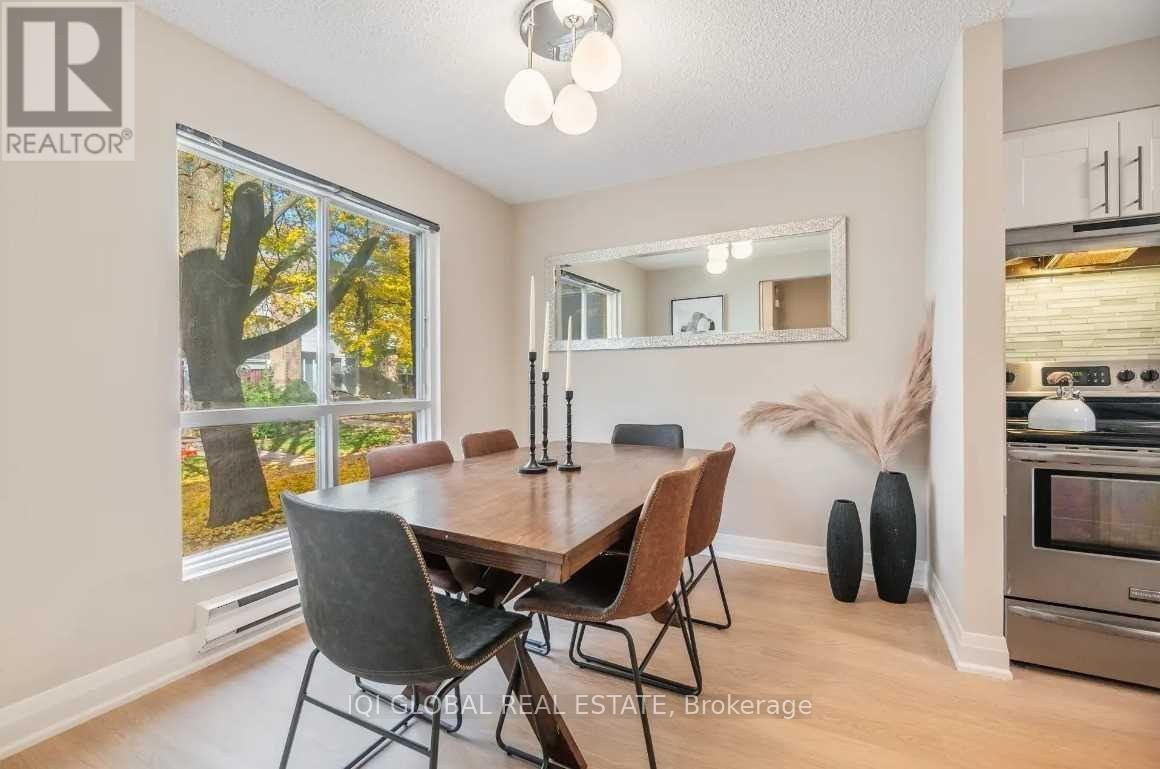 A dining room with a wooden table and chairs.