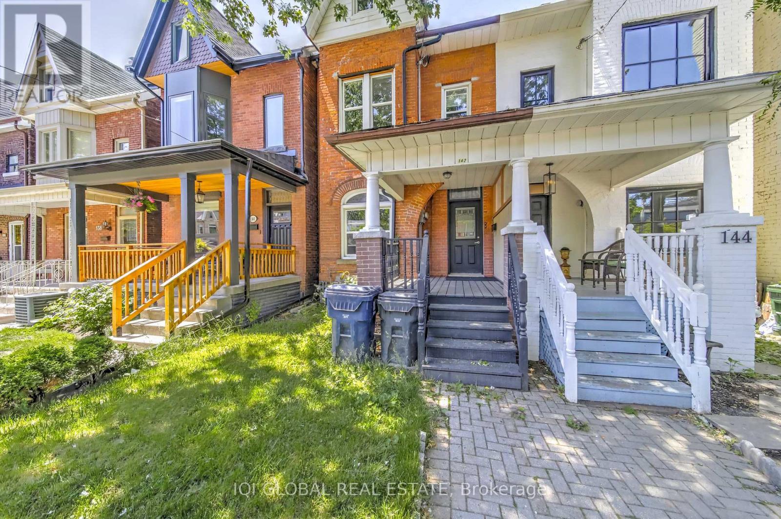 A house with a front yard and a porch.