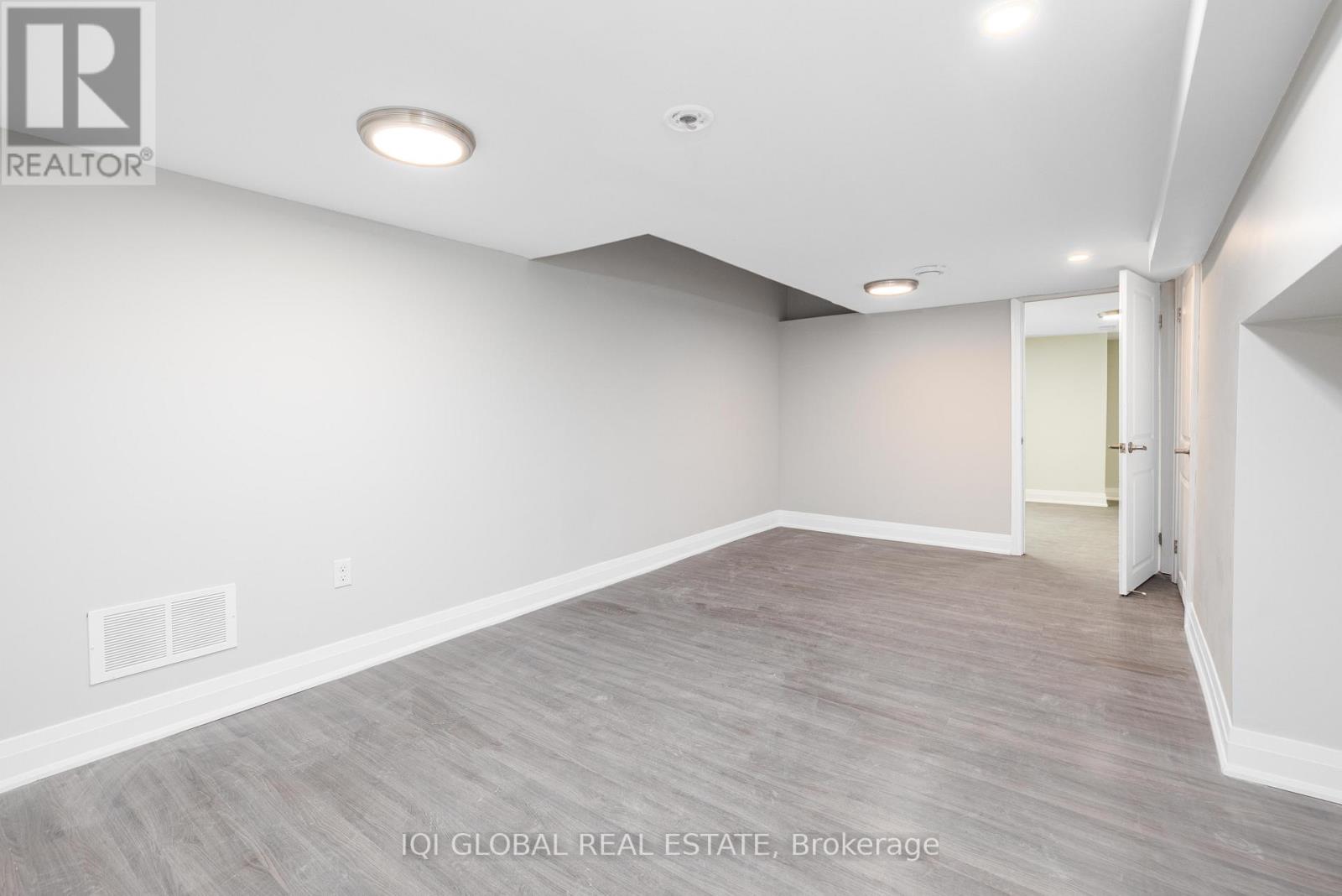 A spacious room with a door on the right side.