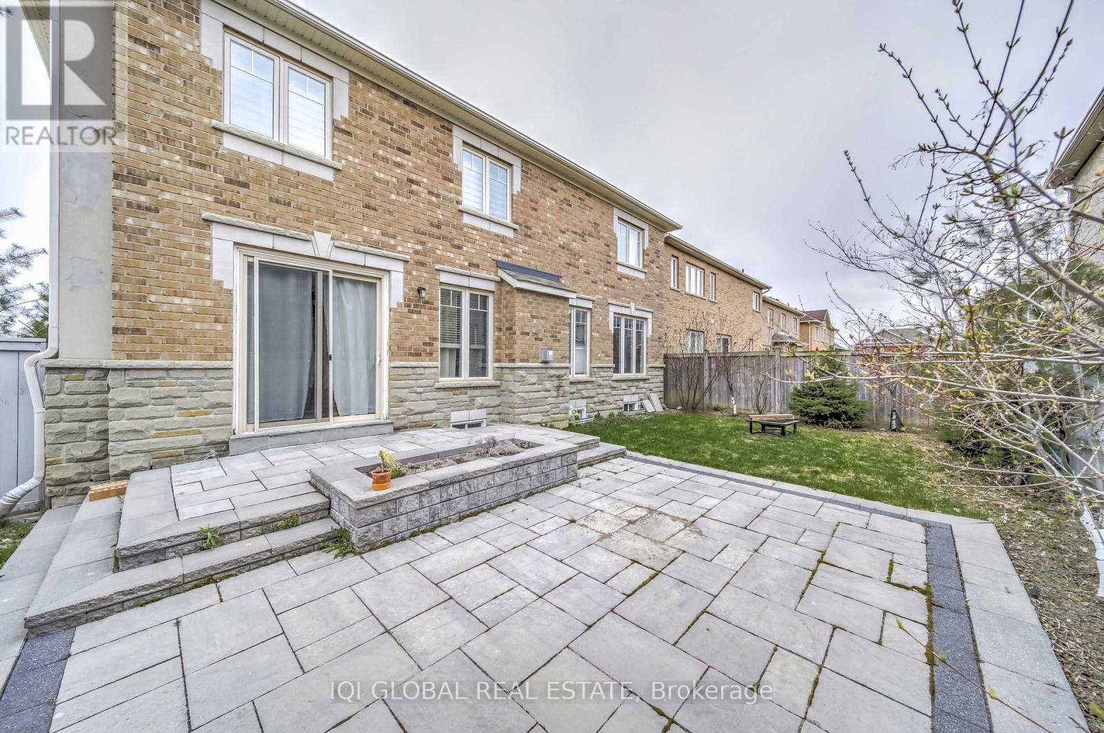 A brick house with a stone walkway leading to the front door.