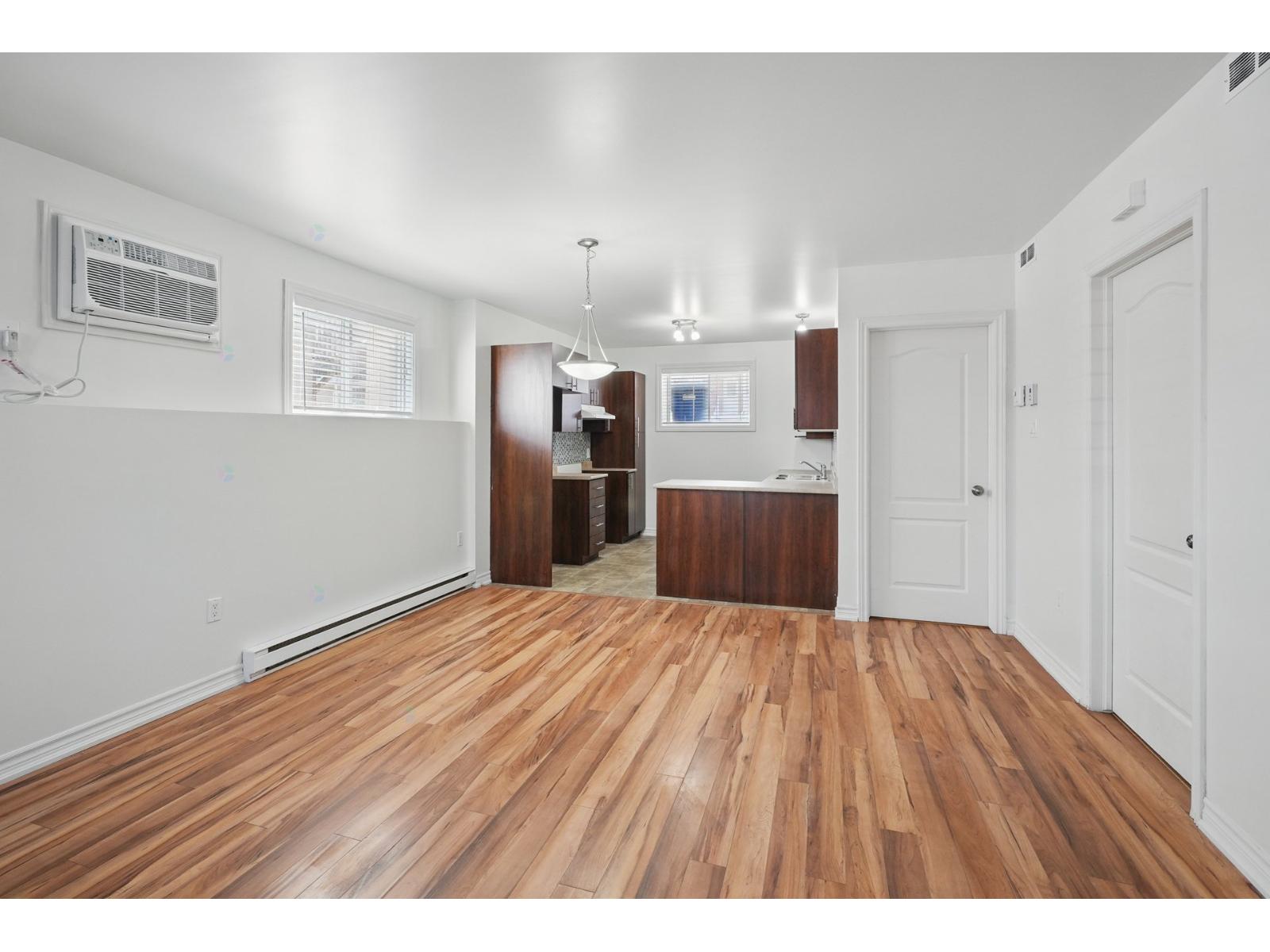 A room with wooden floors and white walls.