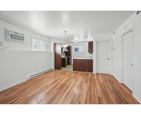 A room with wooden floors and white walls.