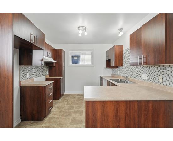 A kitchen with brown cabinets and a counter top.