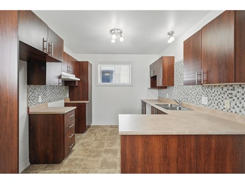 A kitchen with brown cabinets and a counter top.
