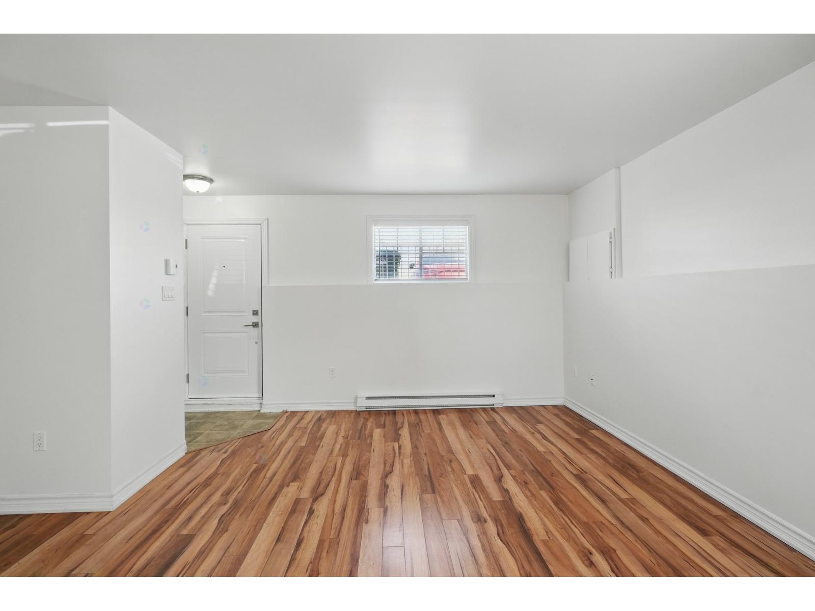 A room with wooden floors and white walls.