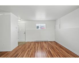 A room with wooden floors and white walls.