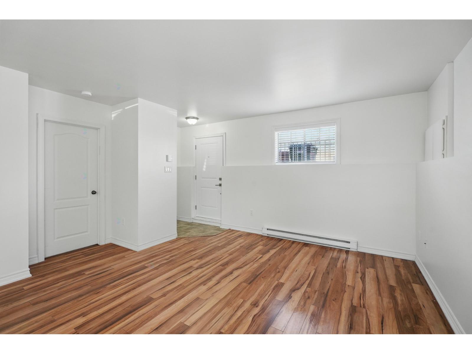 A room with wooden floors and white walls.