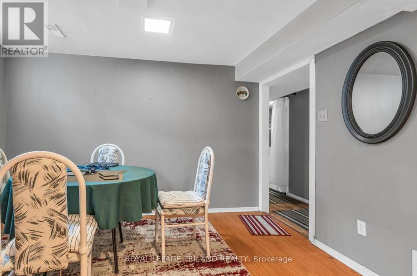 A dining room with a table set for two and chairs with a patterned design.