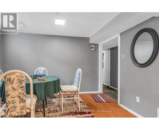 A dining room with a table set for two and chairs with a patterned design.