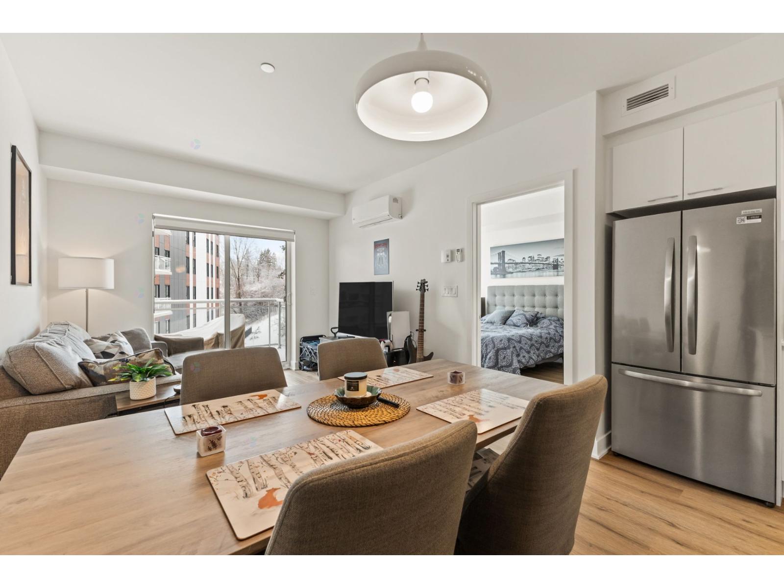 A modern dining room with a wooden table and chairs.