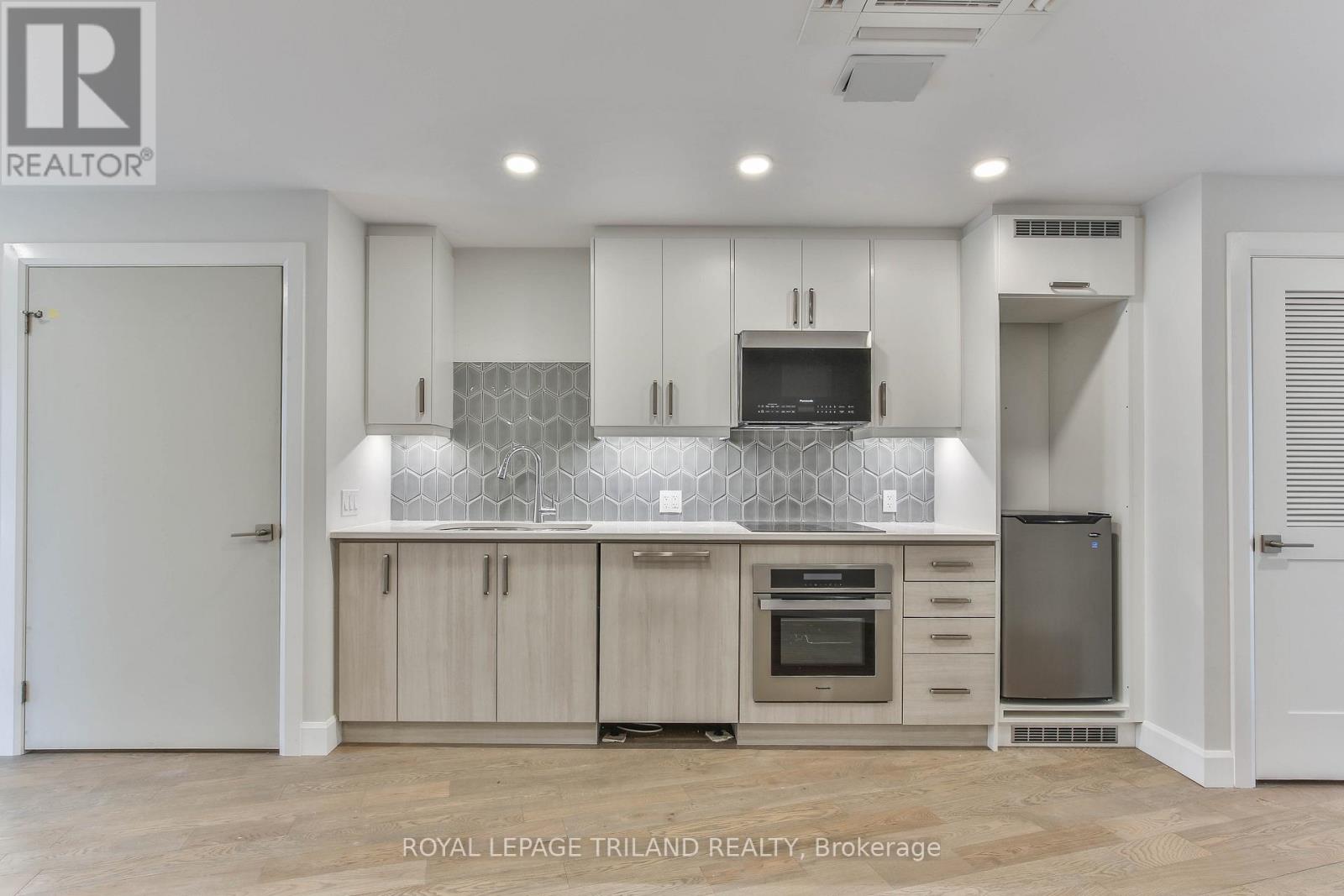A modern kitchen with wooden cabinets and a central island.