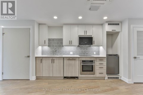 A modern kitchen with wooden cabinets and a central island.