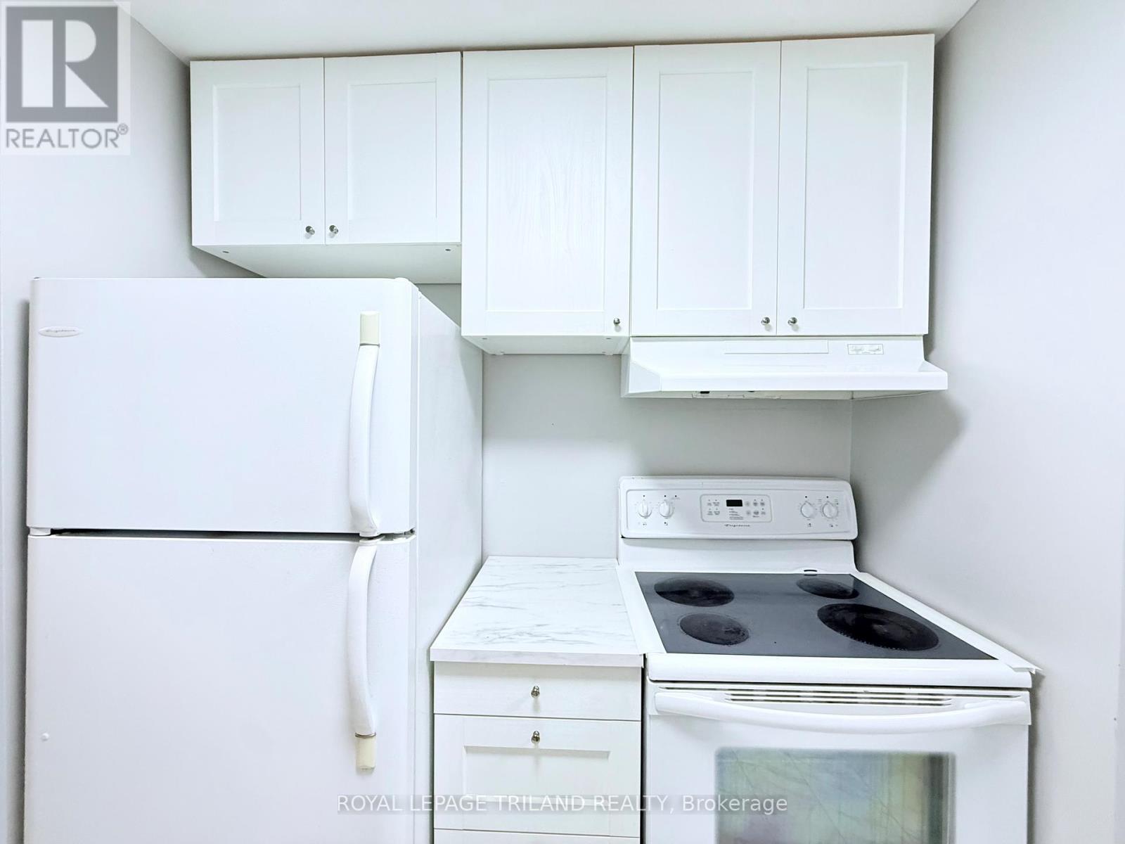 A white refrigerator and stove in a kitchen.