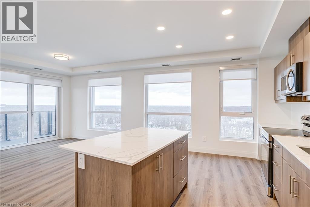 A well-lit kitchen with wooden cabinets and a large island.