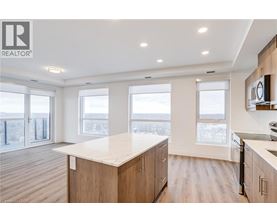 A well-lit kitchen with wooden cabinets and a large island.