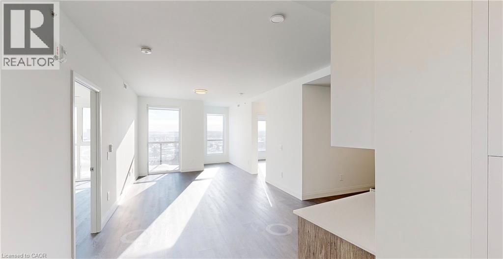 A realtor logo is on a wall in a spacious room.
