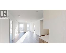 A realtor logo is on a wall in a spacious room.