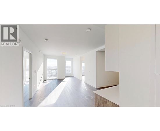 A realtor logo is on a wall in a spacious room.