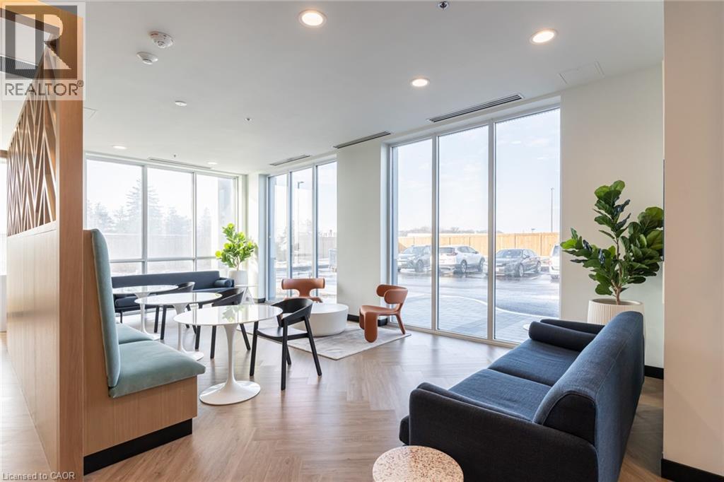 A living room with a blue couch and a wooden chair.