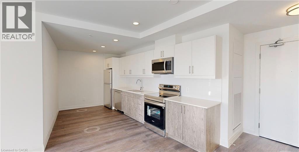 A modern kitchen with white cabinets and a wooden island.