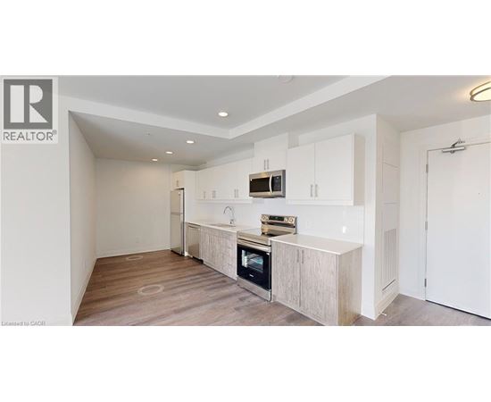 A modern kitchen with white cabinets and a wooden island.