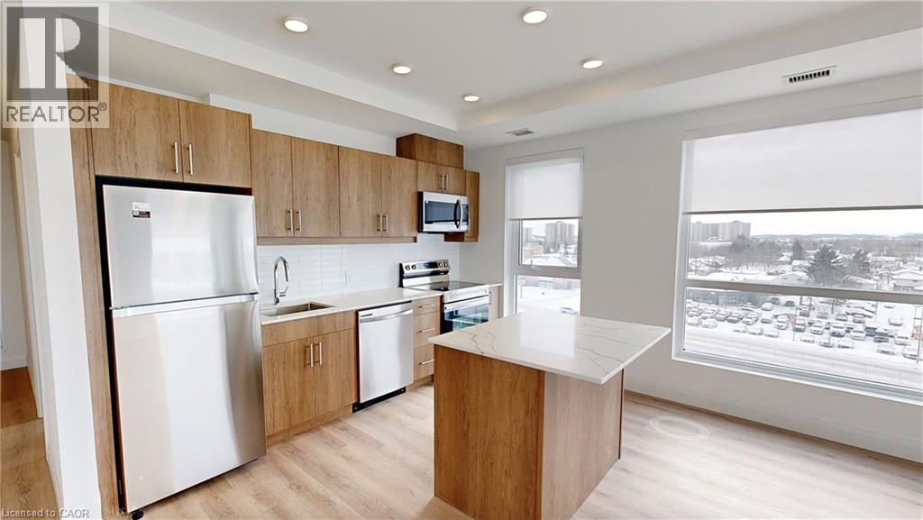 A modern kitchen with wooden cabinets and stainless steel appliances.