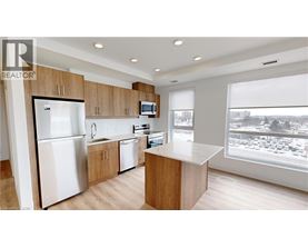 A modern kitchen with wooden cabinets and stainless steel appliances.