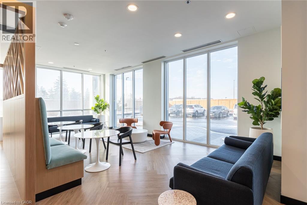 A living room with a blue couch and a wooden chair.