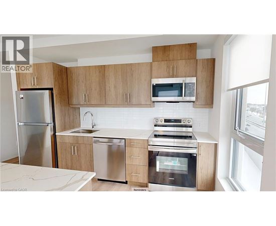 A kitchen with wooden cabinets and stainless steel appliances.