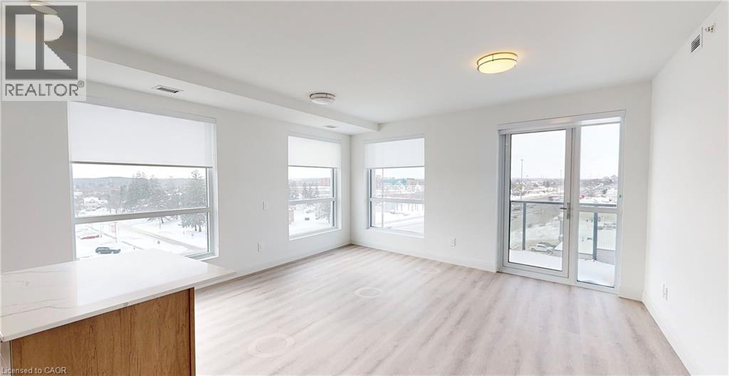 A spacious room with a large window and sliding glass doors.