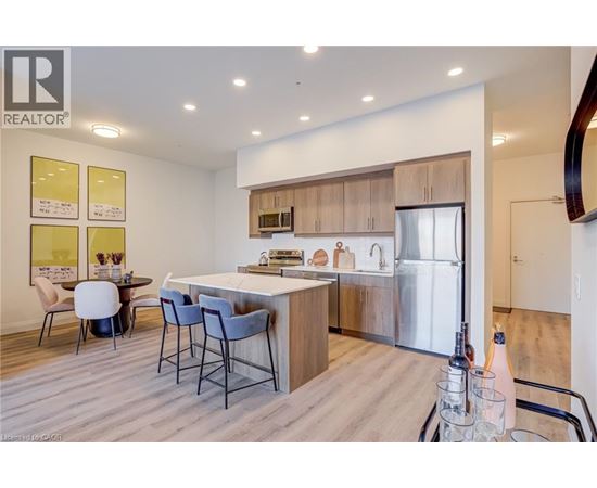 A modern kitchen with a dining table and chairs.