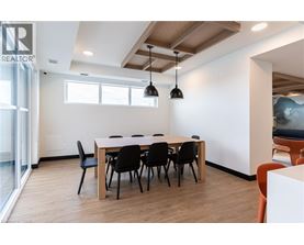 A conference room with a long table and chairs.
